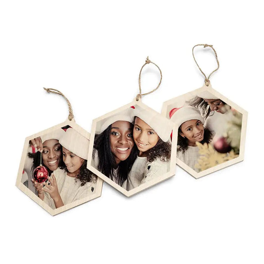 Three wooden photo lockets in the Hexagon Wood Ornament Set on a white background